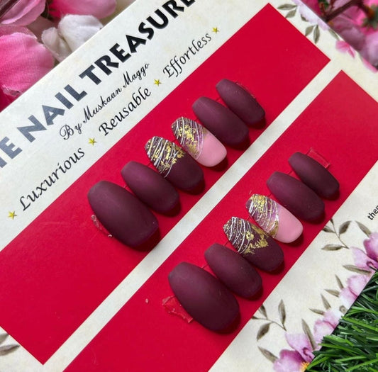 Frosting- A matte press on nail design. Handpainted with gel based wine colour with added spider art & golden foil art.