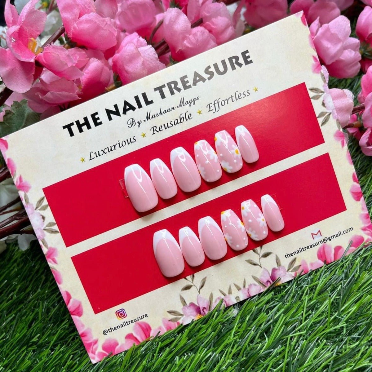 Soft pink base with handpainted flower & french art press on nails set serena by the nail treasure.